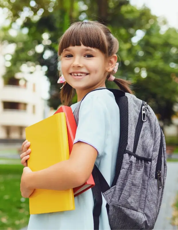 child standing holding books